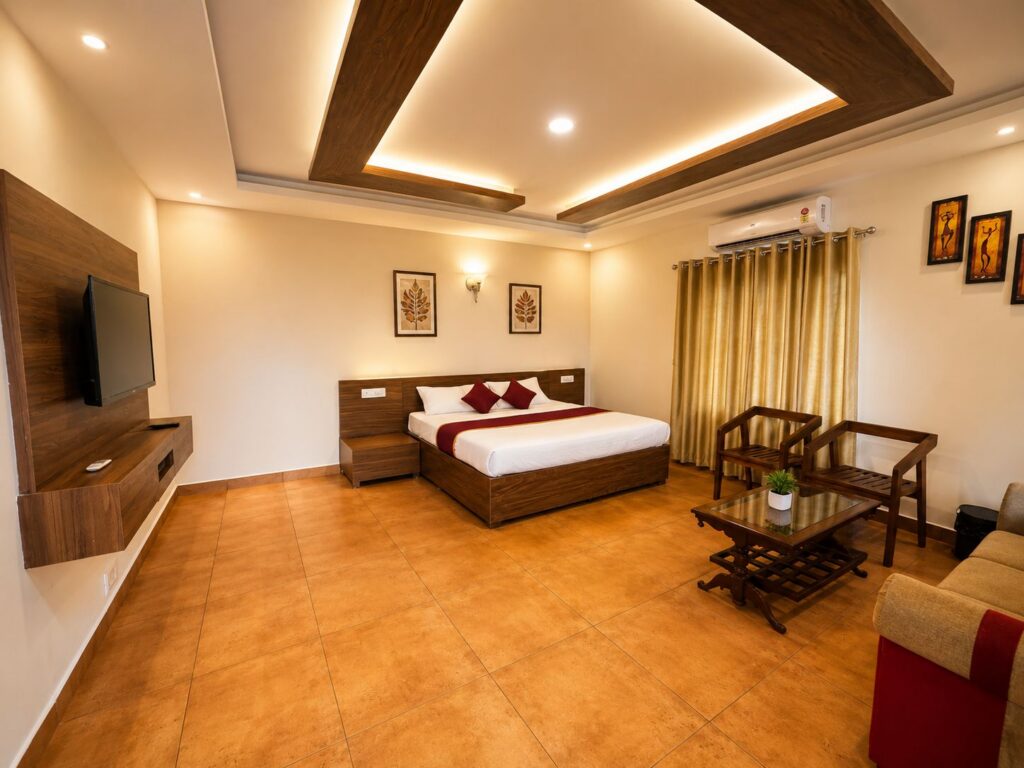 Rooms & Cottages 1 Premium Cottage Bedroom at Wayanad Lakeshore Resort with air conditioning, minibar, kettle and comfortable interiors