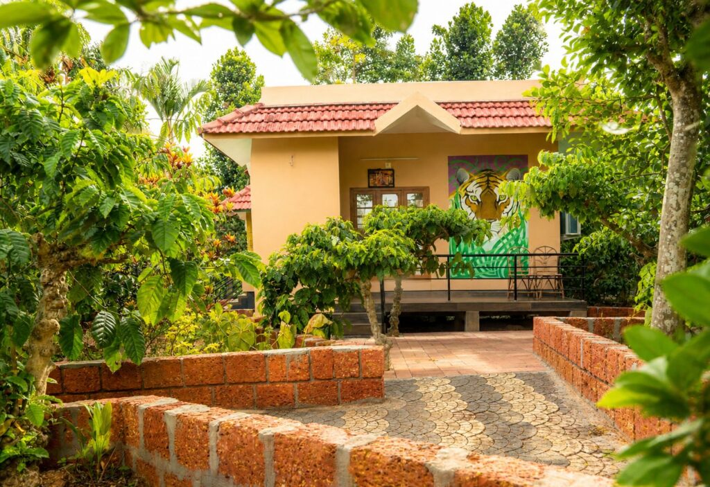 Rooms & Cottages 9 Exterior view of Classic Cottage B2 at Wayanad Lakeshore Resort surrounded by coffee plantation greenery